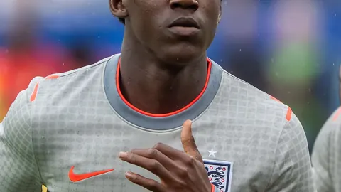 Kobbie Mainoo warming up in an England training top
