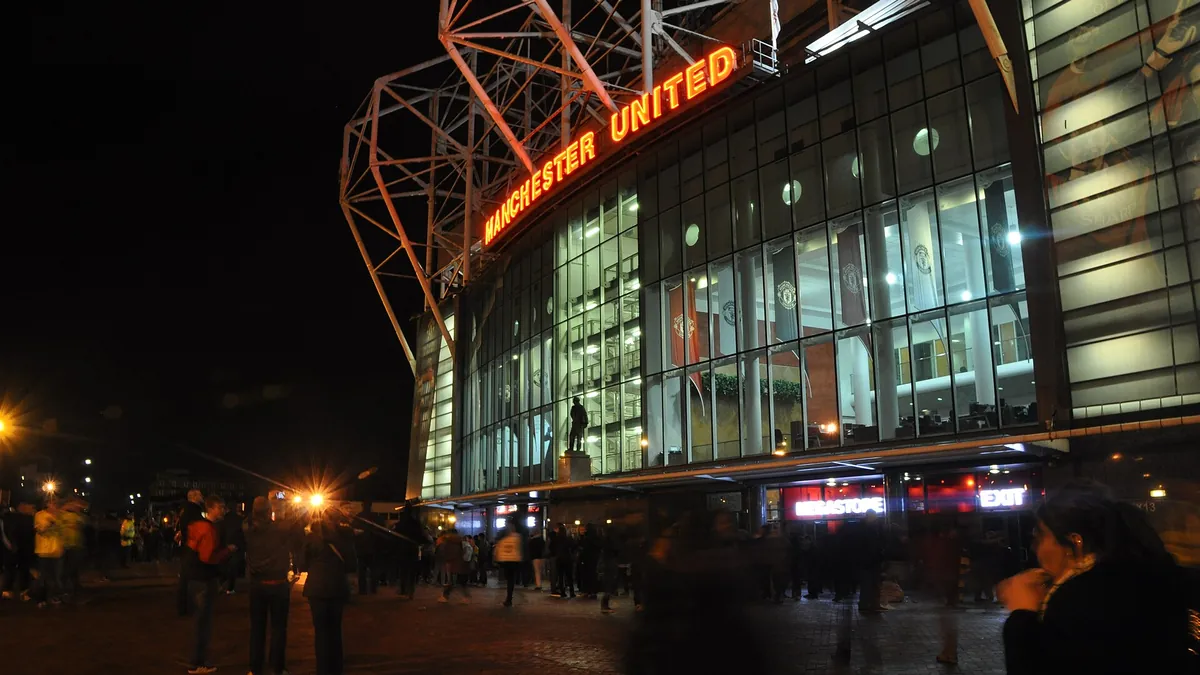 Old Trafford stadium exterior at night