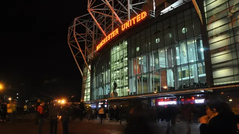 Old Trafford stadium exterior lit up at night