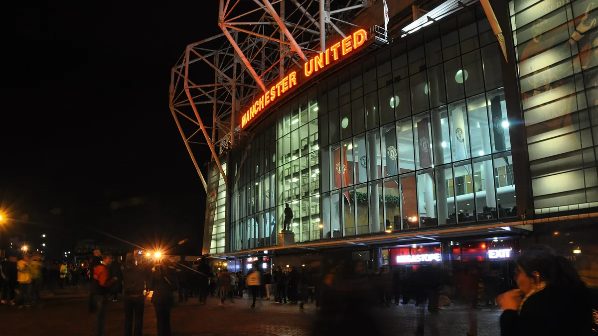 Old Trafford stadium exterior lit up at night