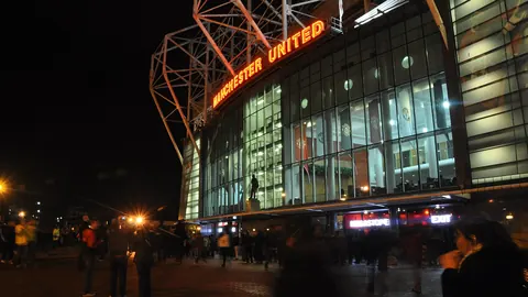 Old Trafford stadium exterior at night
